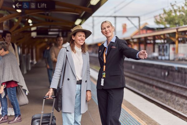 A train link employee helping a member of the public