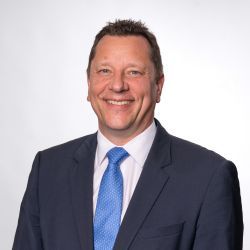 A headshot of Paul Scully